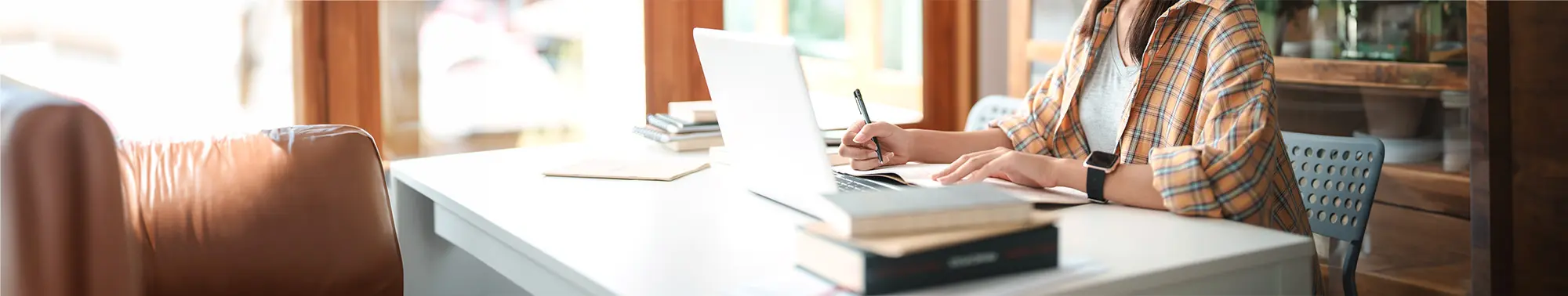 Person working on a laptop at a desk.